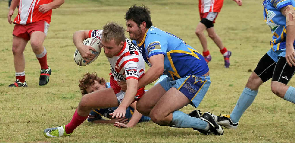 Killarney Cutters centre Jake Kitching looks for the line as Wallangarra Rams players try to stop him scoring.